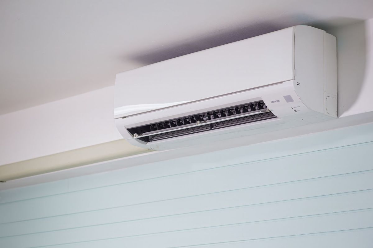 Wall-mounted air conditioning unit in a room.