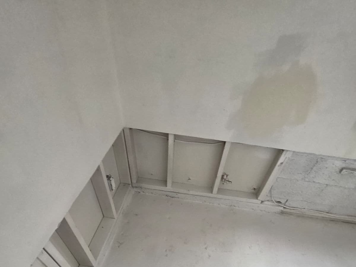 Stain on a wall above a section where the drywall was cut out.